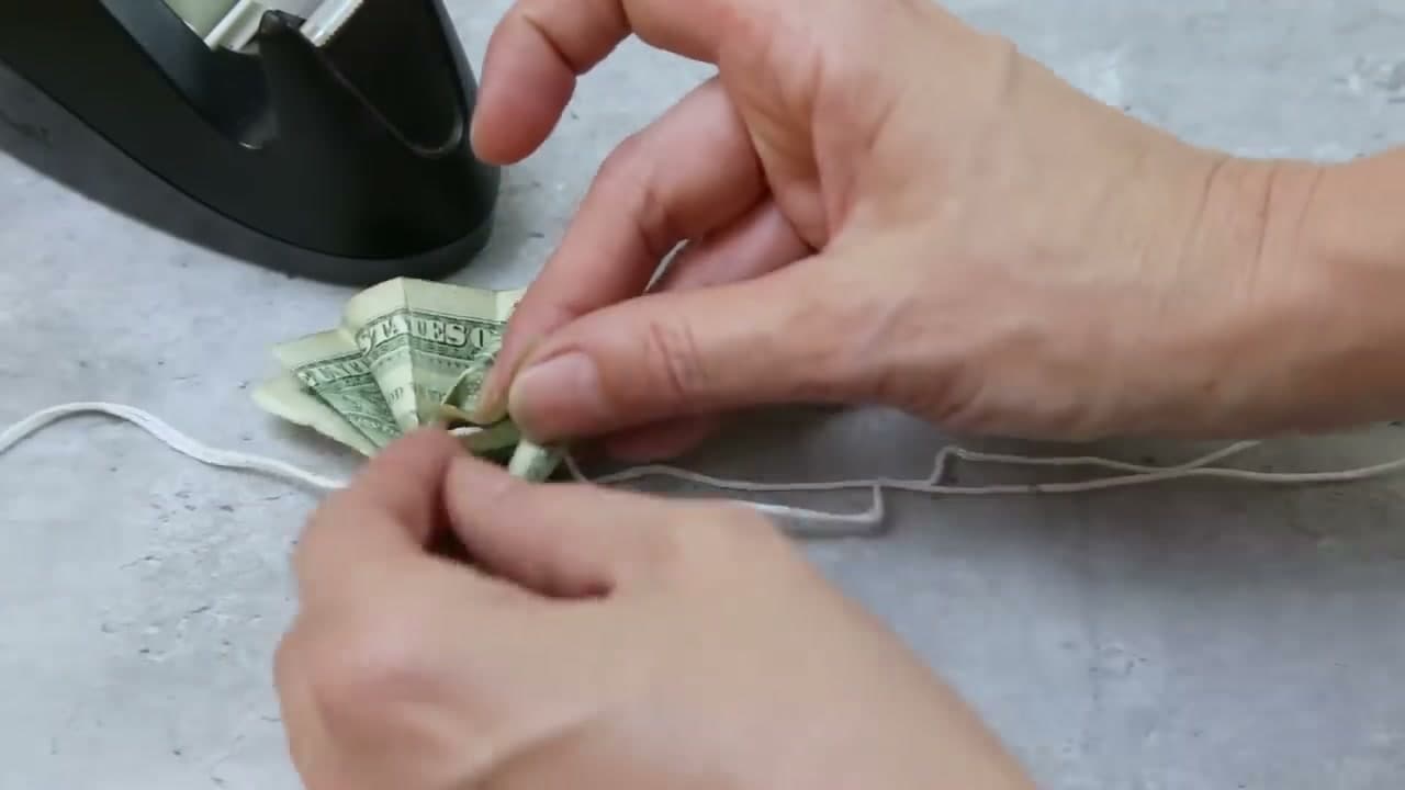 Step 9: Step 9: Thread a Bill onto the String and Tape It Closed