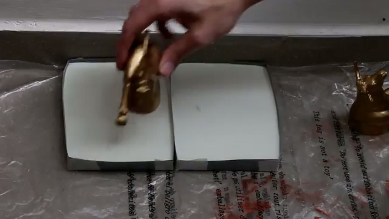 Step 5: Set the Gold Animals into the Concrete - How to Make Concrete Bookends with Gold Animals
