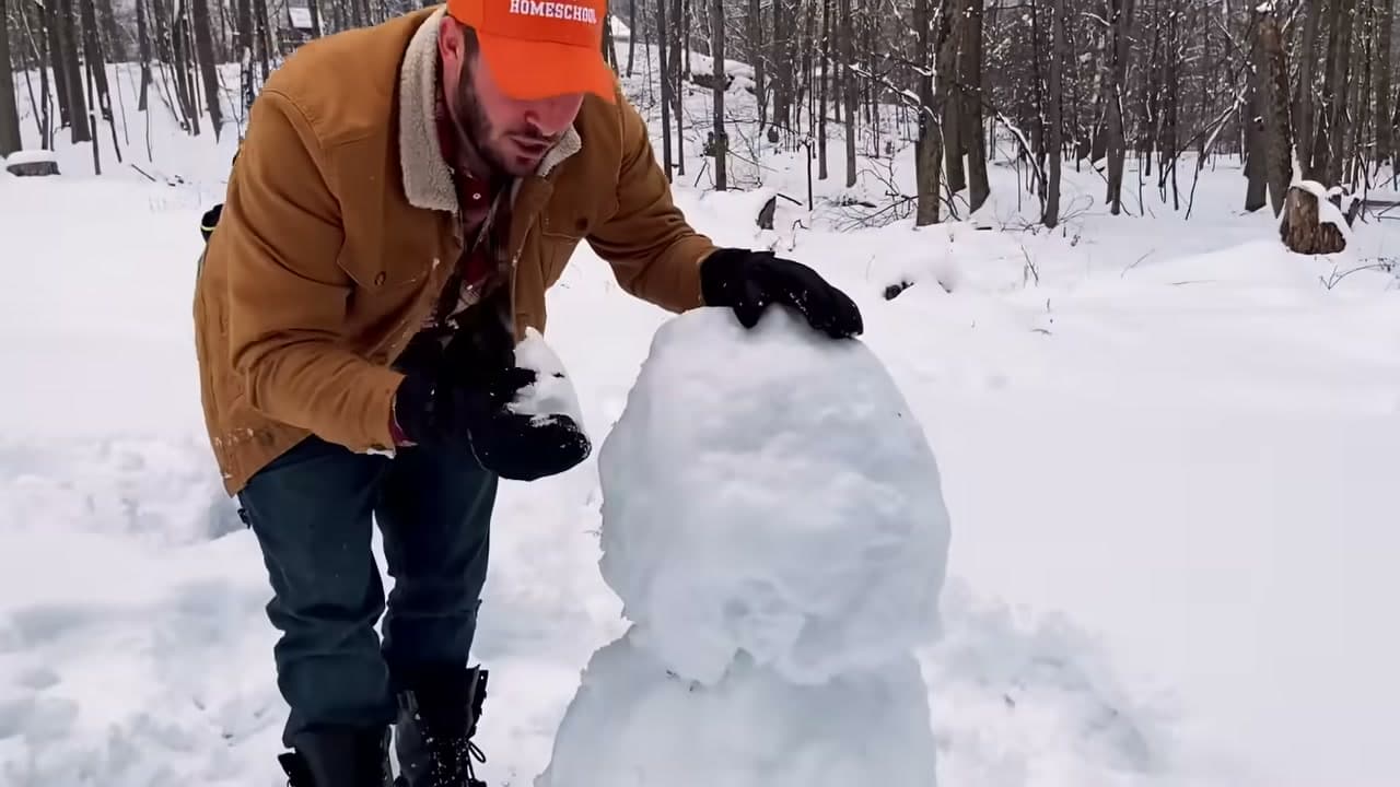 Step 3: Lift the Middle Snowball Onto the Base - How to Make a Snowman