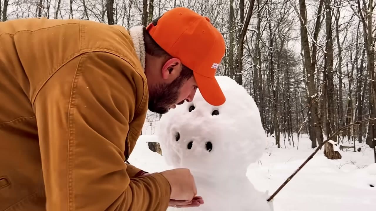 Step 7: Press Stone Eyes and a Stone Mouth Into the Snowman's Face - How to Make a Snowman