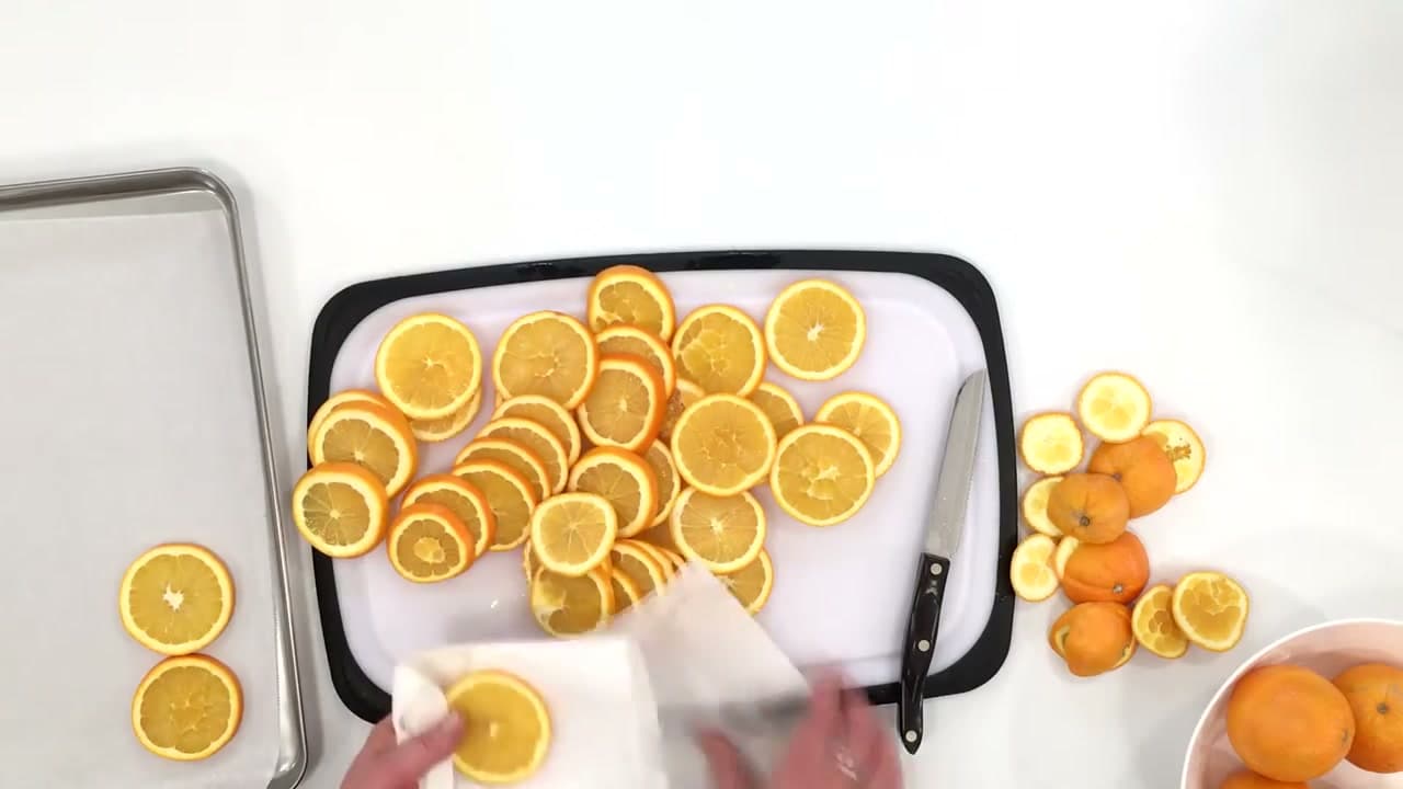 Step 2: Blot the Slices and Lay Them on Parchment-Lined Sheet Pans - How to Dry Orange Slices