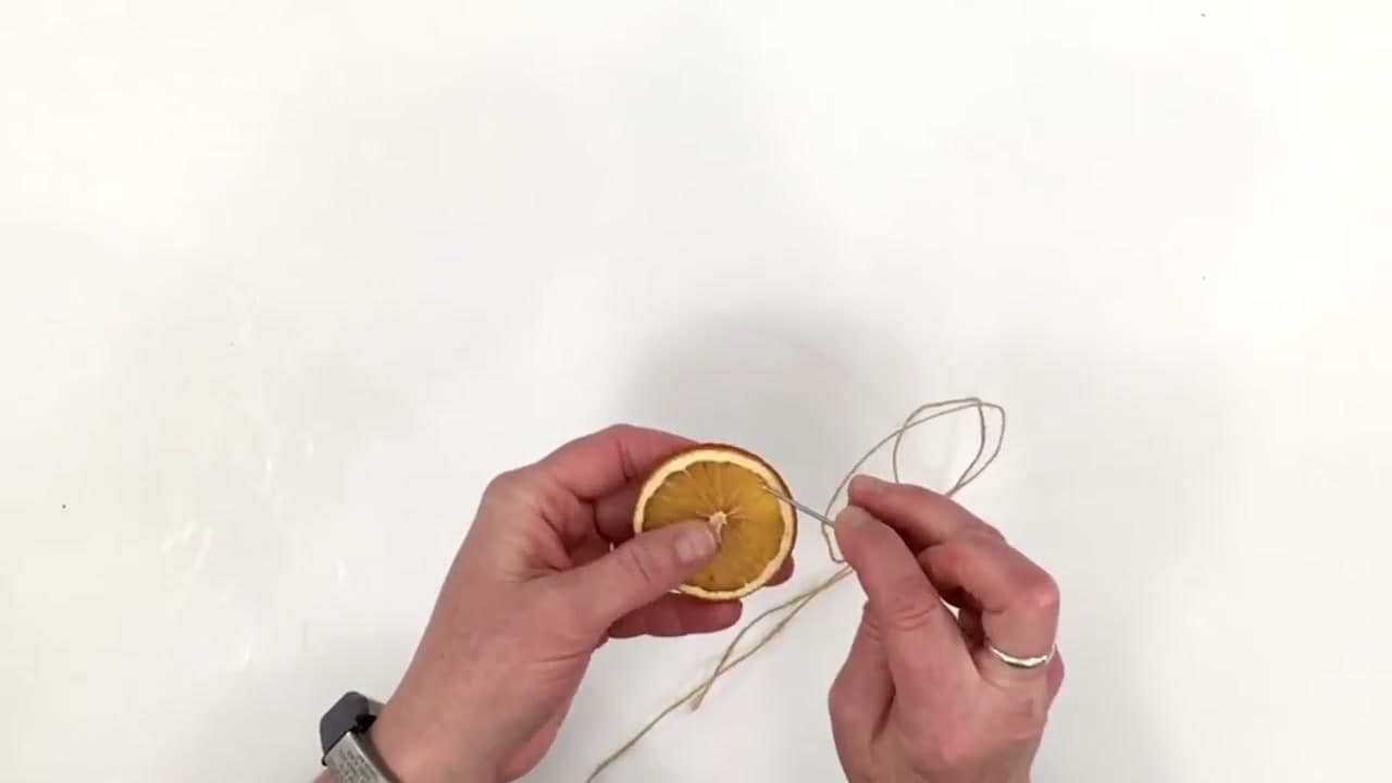 Step 6: Thread Jute on a Yarn Needle and Poke Holes at 11 and 1 O'Clock - How to Dry Orange Slices