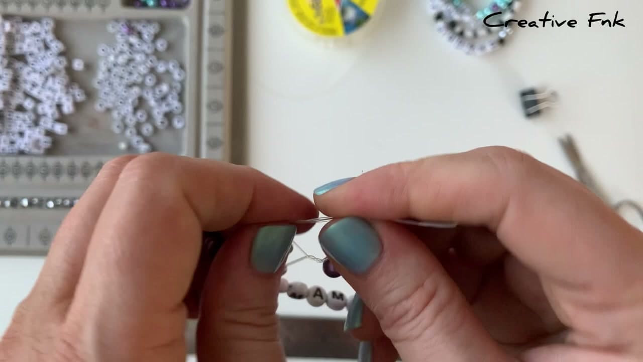 Step 7: Tie a surgeon's knot - How to Make a Letter Bead Friendship Bracelet