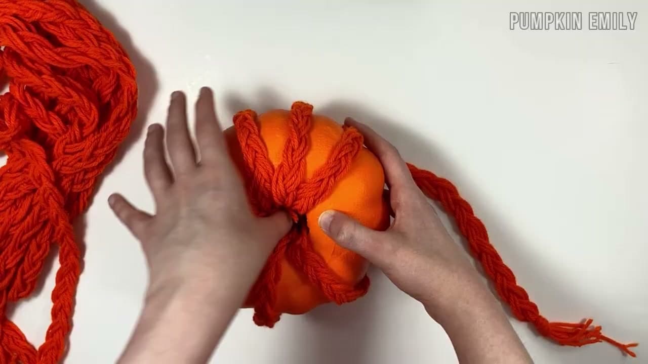 Step 8: Lay Braids Across the Pumpkin and Tuck the Ends In - How to Make a No-Crochet Yarn Pumpkin (2 Easy Methods)