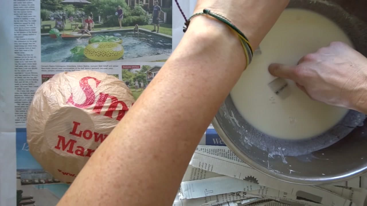 Step 4: Dip a Strip and Lay It On - How to Make Paper Mache