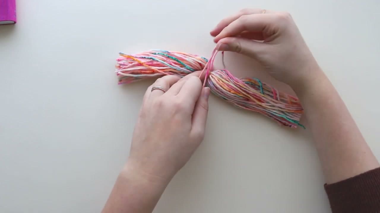 Step 3: Tie a Scrap Strand Around the Middle of the Bundle - How to Make a Tassel and Attach It to Any Project