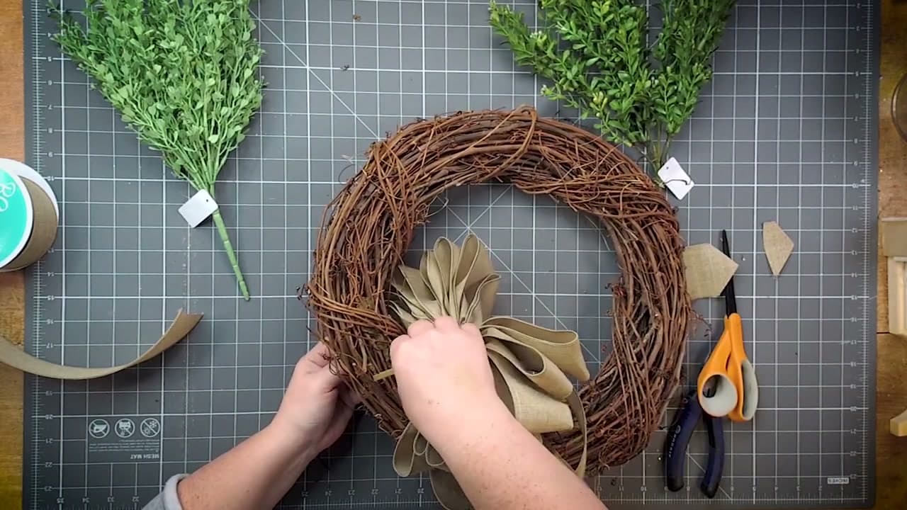 Step 7: Push the Wire Through the Grapevine From the Front - How to Make a Wreath